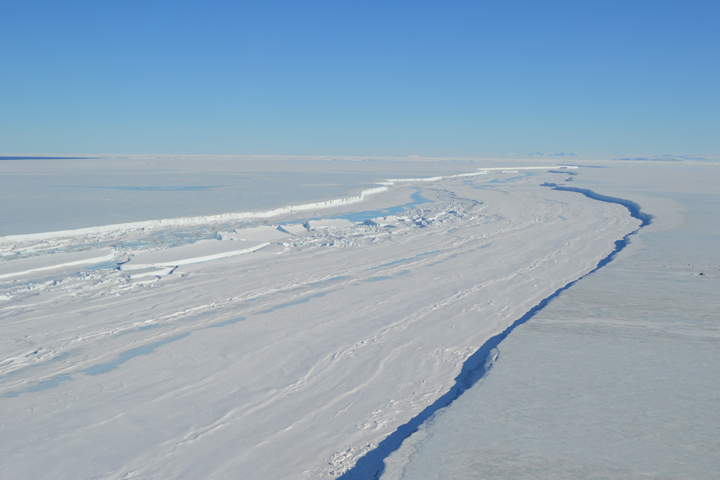 NASA image from December 2015 of a long crack in the Nansen ice-shelf on the Antarctic coast. In early March 2016, with southern winter soon to set in, satellite imagery indicated that the cracking ice front was still attached to the shelf. Even in winter, strong winds can prevent the water beyond the shelf from freezing, so it is unclear whether the front will separate soon or hang on like a loose tooth.
